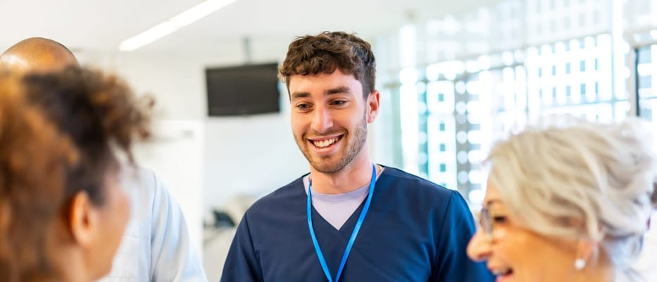 Staff member smiling with residents in a group