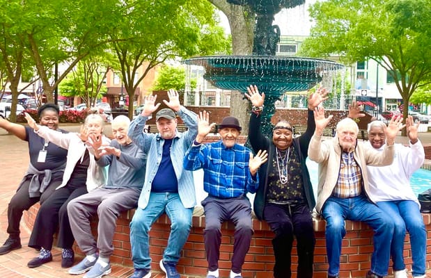 Residents enjoying a sunny day by a fountain