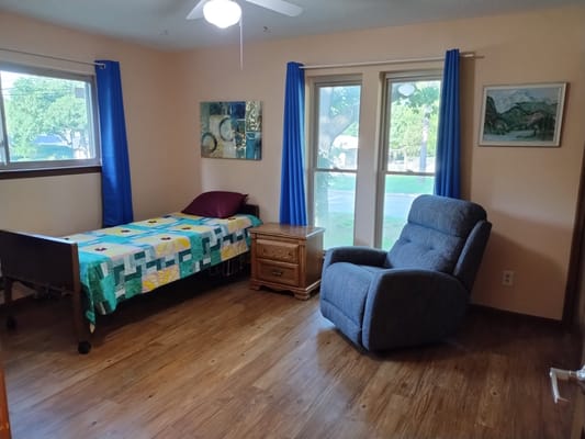 Cozy resident room with a bed and a recliner
