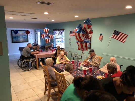 Residents celebrating with decorations and food in a dining area