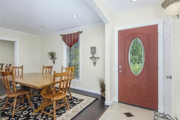 Wooden dining table with chairs in a well-lit room