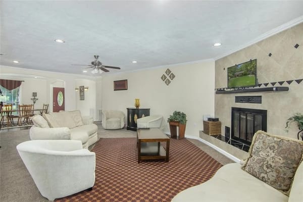 A cozy living room with comfortable seating and a TV.