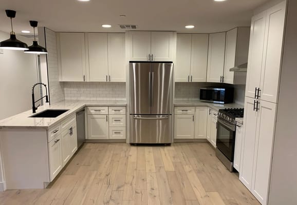 Well-equipped kitchen with stainless steel appliances and marble countertops