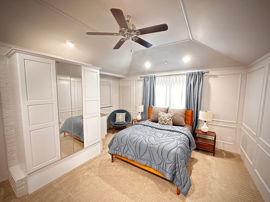 Cozy interior view of a resident room with bedding and furniture