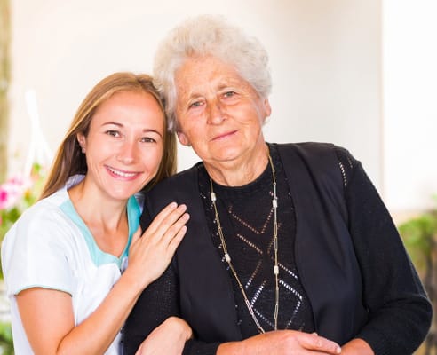 Caregiver with a resident in a facility setting