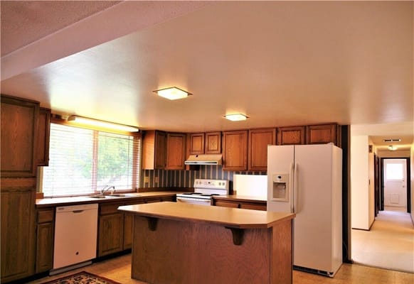 Bright kitchen interior with wooden cabinets and appliances