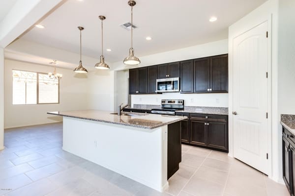 Bright kitchen with dark cabinets and modern appliances