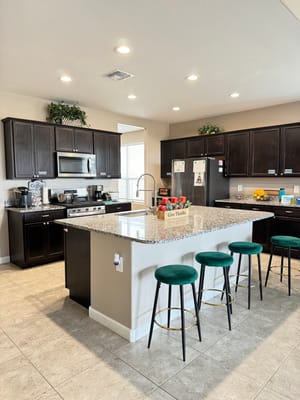 Modern kitchen with granite countertops and seating