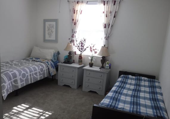 A shared resident room with two beds and decor