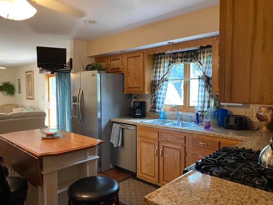 Kitchen area with wooden cabinets and appliances