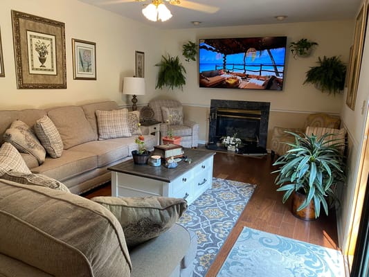 Comfortable living room with a sectional sofa, decorative pillows, and a large TV.