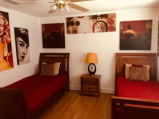 A cozy, decorated interior bedroom with twin beds