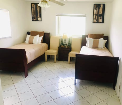 Brightly lit shared bedroom with two beds