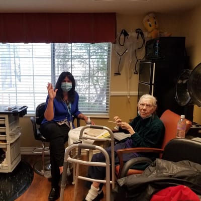 Staff and resident in an interior room