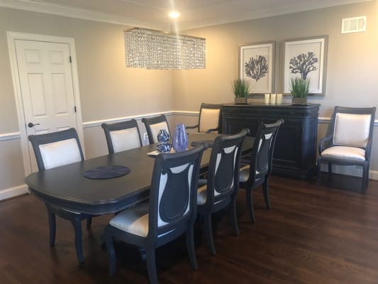 Elegant dining area with a long table and chandelier