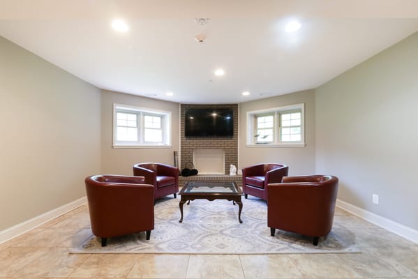 Cozy common area with seating and a fireplace