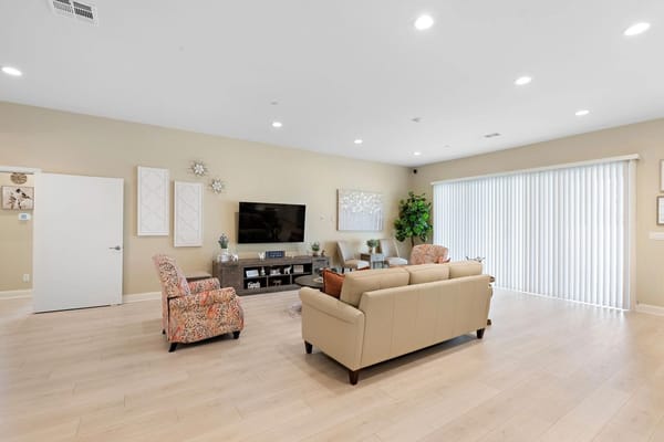 Bright common area with seating and TV
