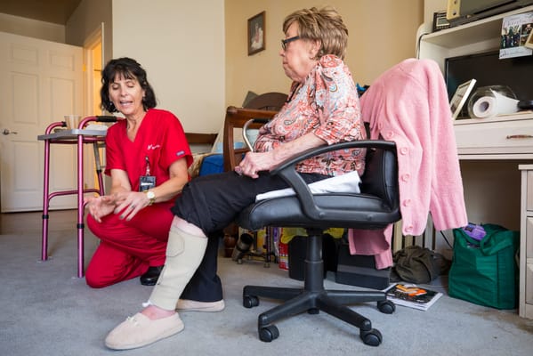 Caregiver assisting resident in a room