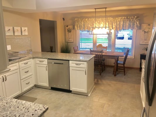 Bright kitchen area with dining table and window view