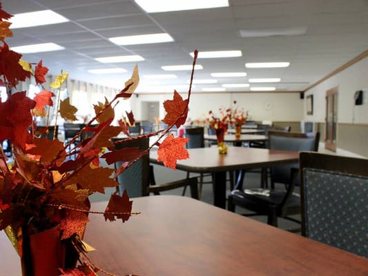 Dining room with autumn decorations and empty tables