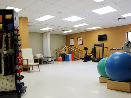 Rehabilitation gym with exercise equipment and therapy tools