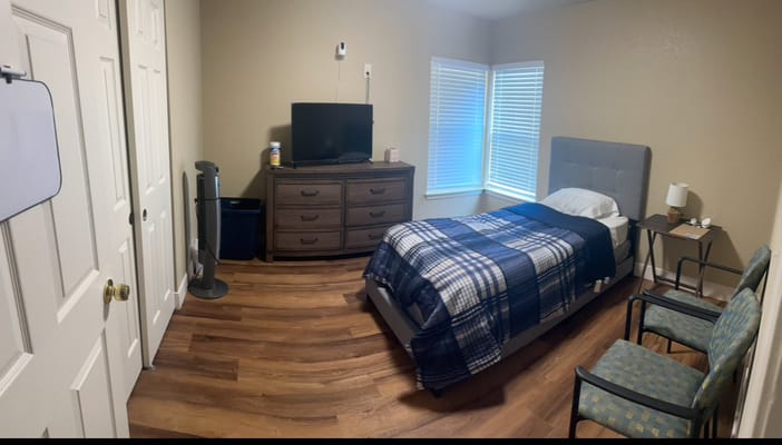 Cozy private resident room with bed and furnishings