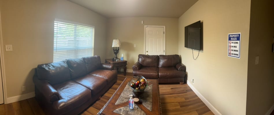 Cozy living room with leather couches and decor