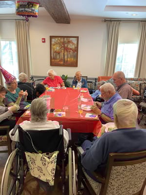 Residents celebrating a birthday with cake and decorations