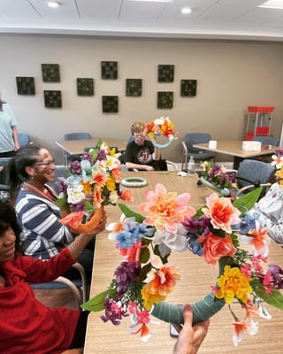 Residents enjoying a flower arrangement activity in a common area