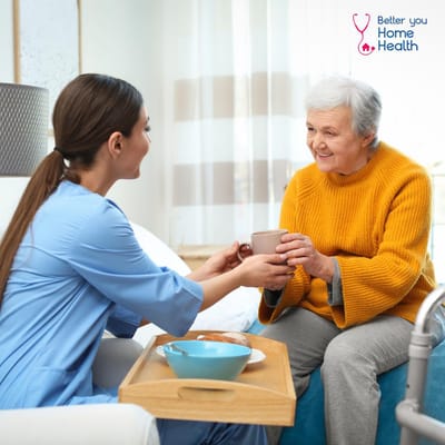 Caregiver assisting a resident with a warm beverage