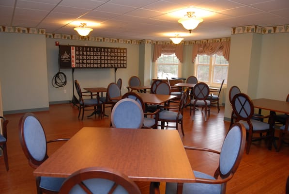 Interior of a recreational room with tables and chairs