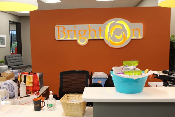 BrightOn logo in a welcoming reception area