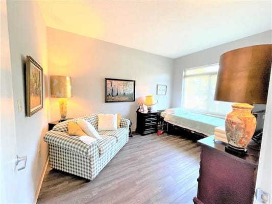 Cozy private resident room with a couch and lamp