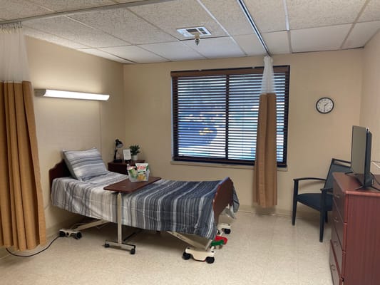 Private resident room with bed and furnishings