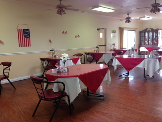 Dining area with red tablecloths and decor