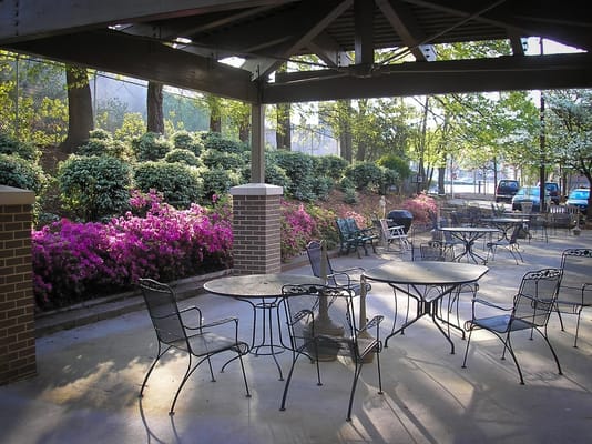 A serene outdoor patio area with tables and seating