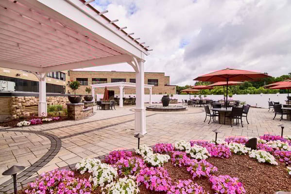 Outdoor patio with flowers and seating areas