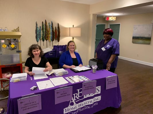 Staff assisting residents at a welcome table