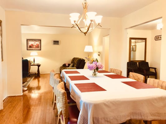 Bright dining room featuring a large table and comfortable seating