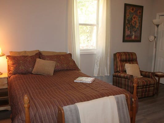 Cozy private bedroom with a bed and chair