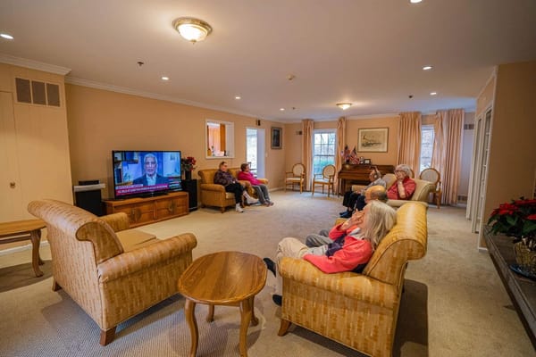 Seniors watching television in a cozy living room