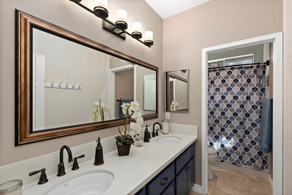 Modern bathroom with double sinks and decorative mirror