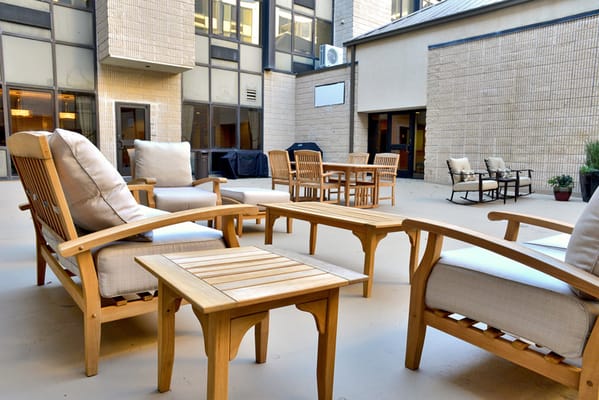 Outdoor seating area with wooden chairs and tables