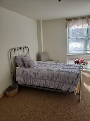 Cozy private room with a bed and decorative items