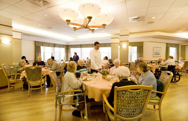Residents dining in a bright dining room setting