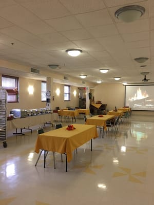 Dining room setup in a bright facility interior