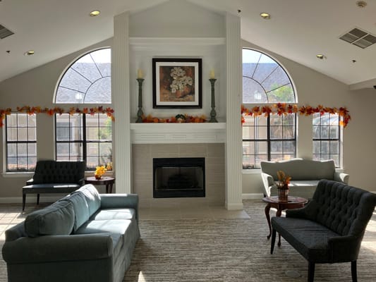 Bright common area with seating and fireplace