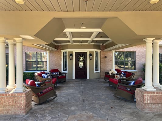 Covered entrance with seating in front of a facility