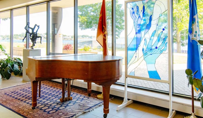 Piano in a common area with large windows and views
