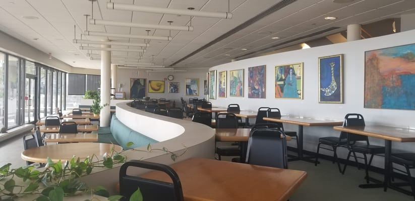 Bright dining area with colorful artwork on the walls